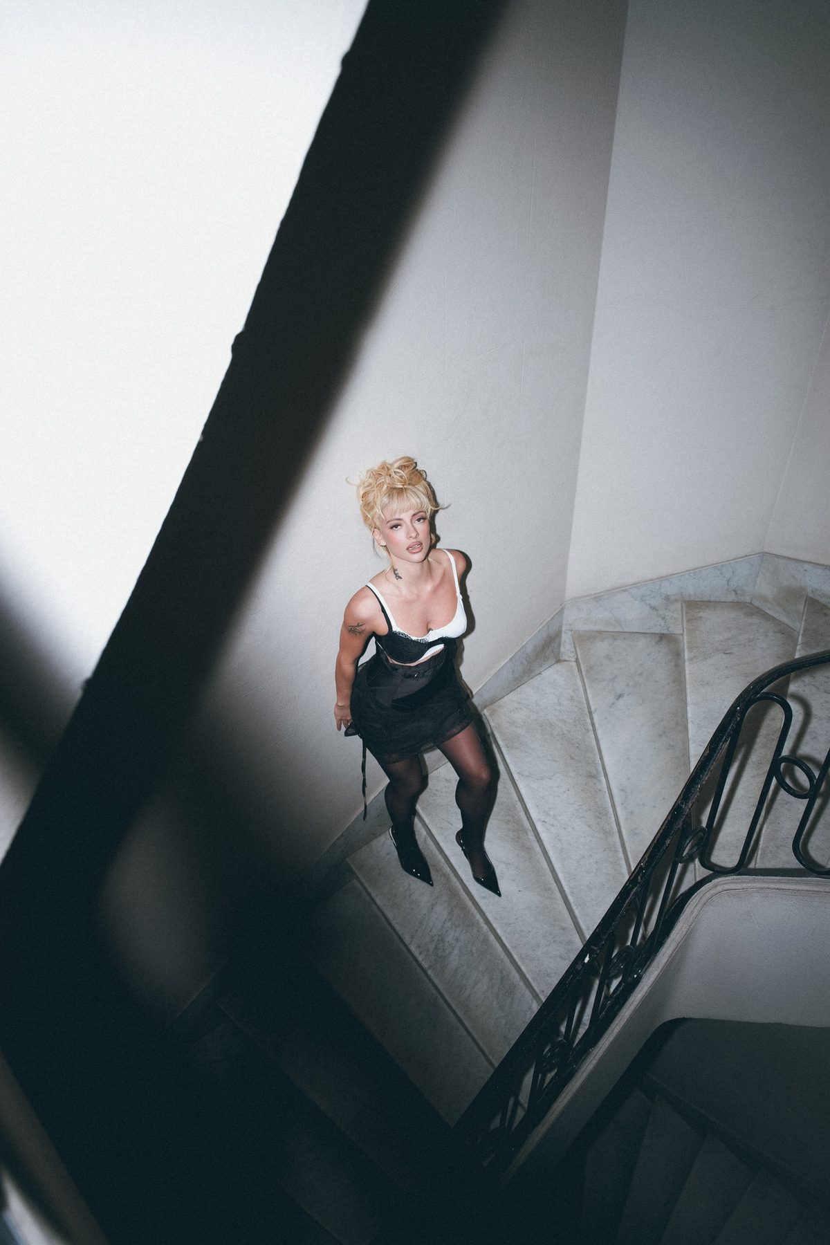 Greta Cozzolino on a marble staircase, shot from above