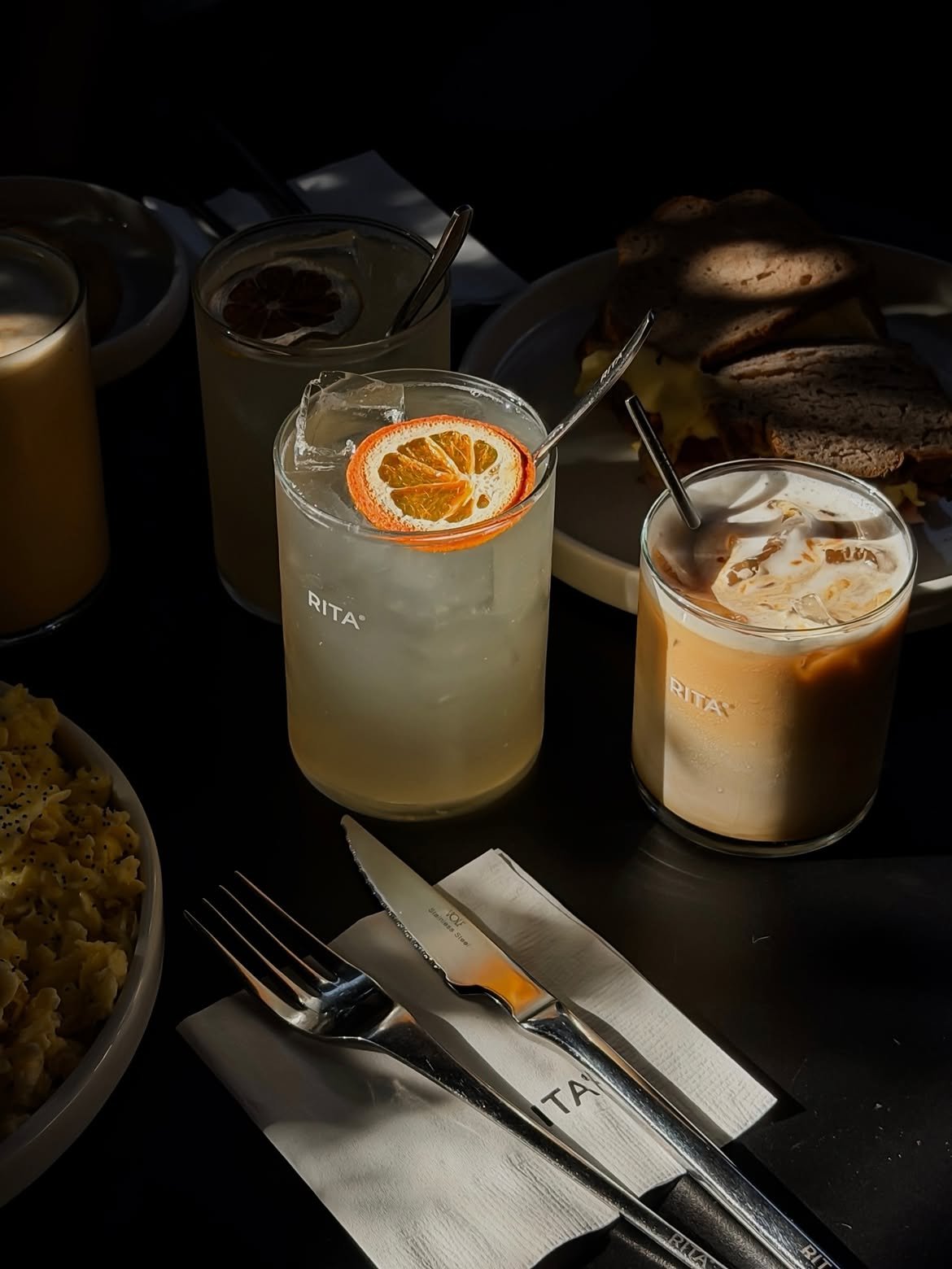 Drinks and breakfast in hard light at Rita