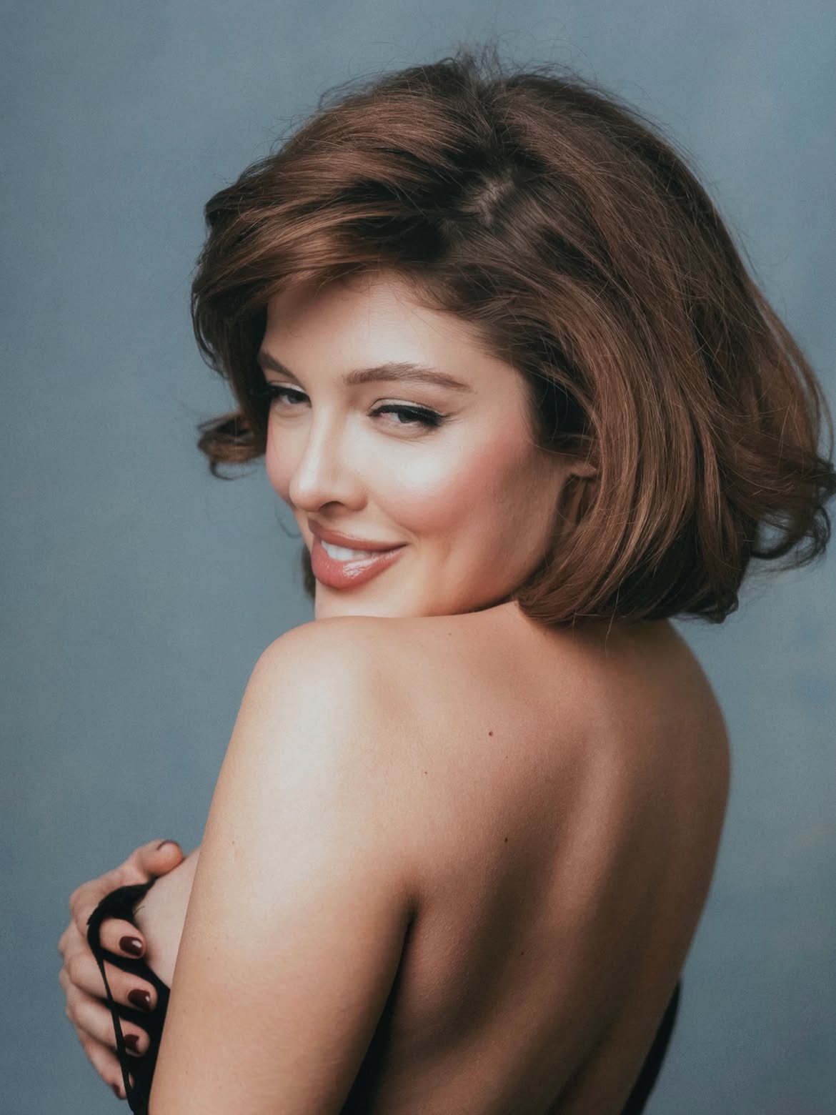 Close portrait of Sofía Gonet smiling over her shoulder